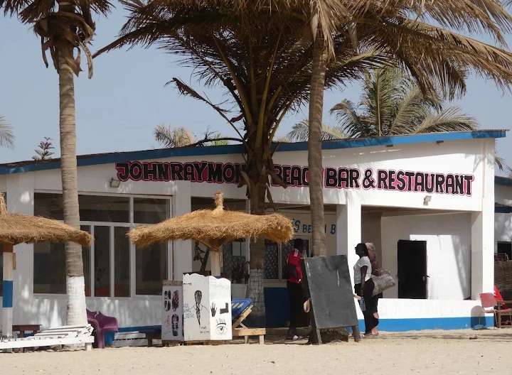 John Raymond's beachfront restaurant exterior with palm trees
